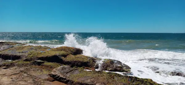 Waves crashing on the beach rocks